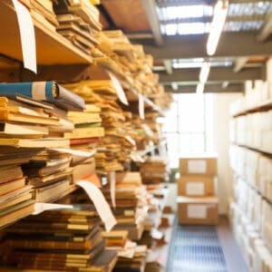 Image of stacks of papers and files in a storage room