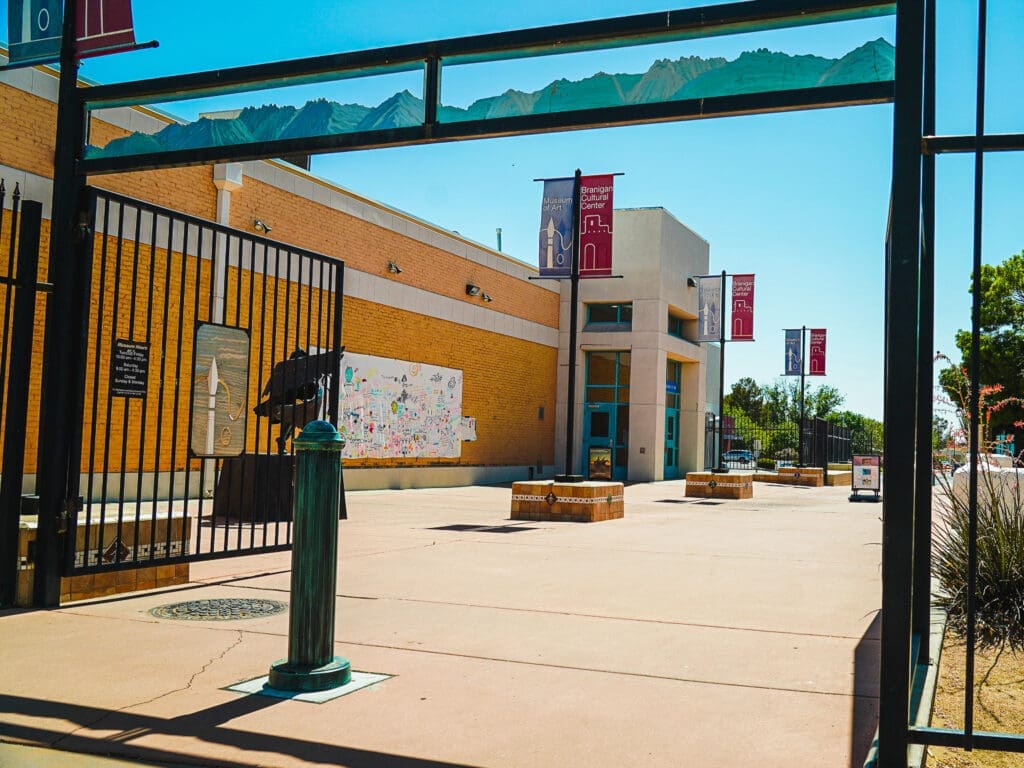 An open gate leading to the plaza between the Museum of Art and Branigan Cultural Center.