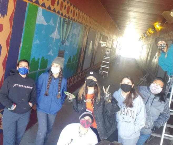 Photo of YCC team members wearing Covid masks in trail tunnel.