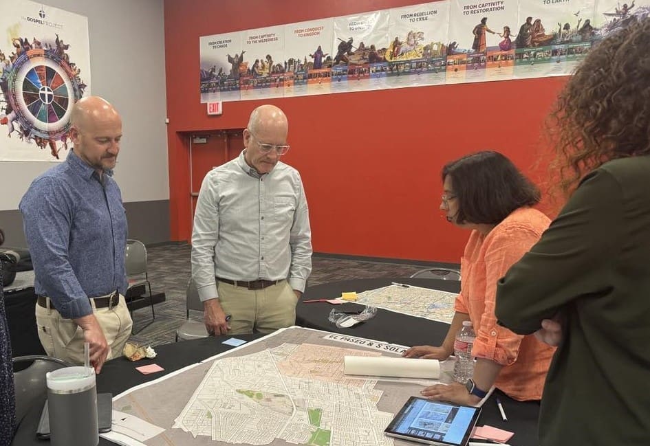 Three people looking at a map