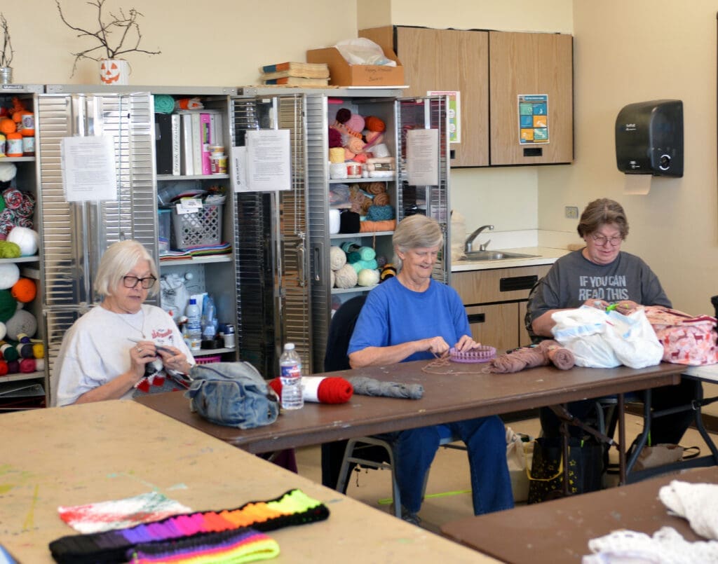 Seniors working on crochet projects at Munson