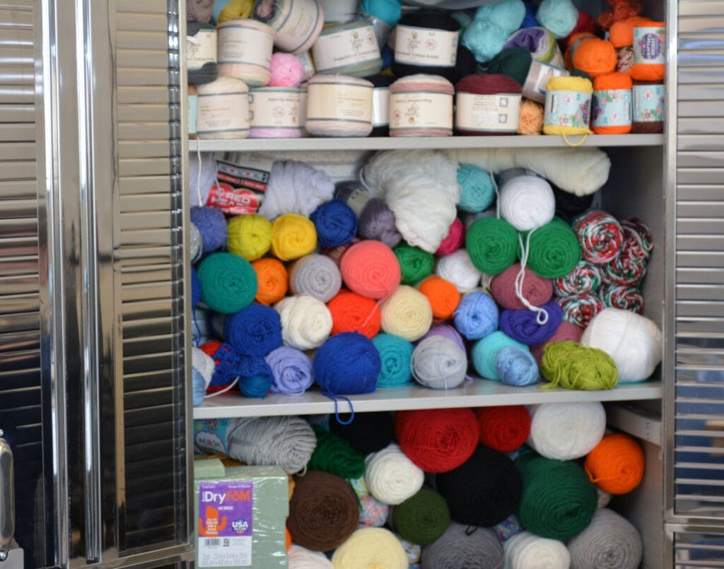 Multiples colors of yarn in a metal cabinet