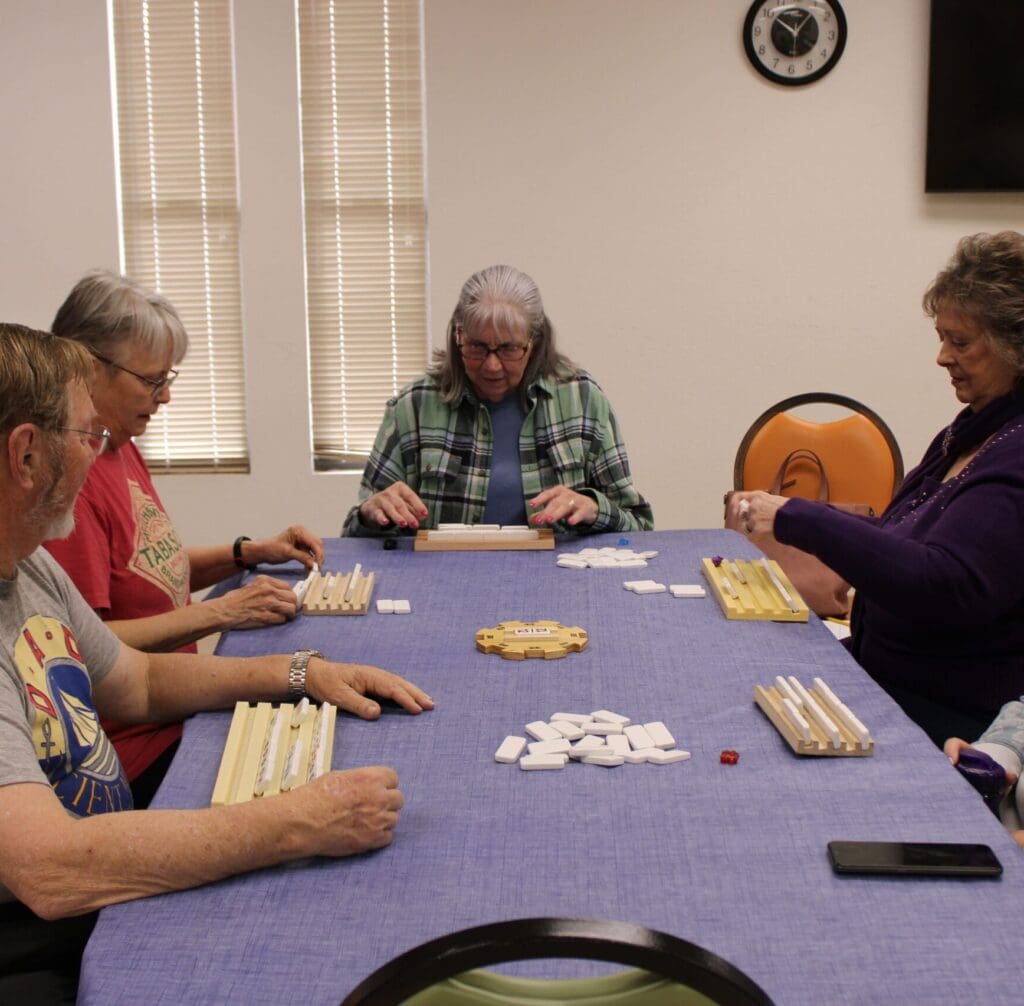 Seniors playing train dominoes at Sage Cafe