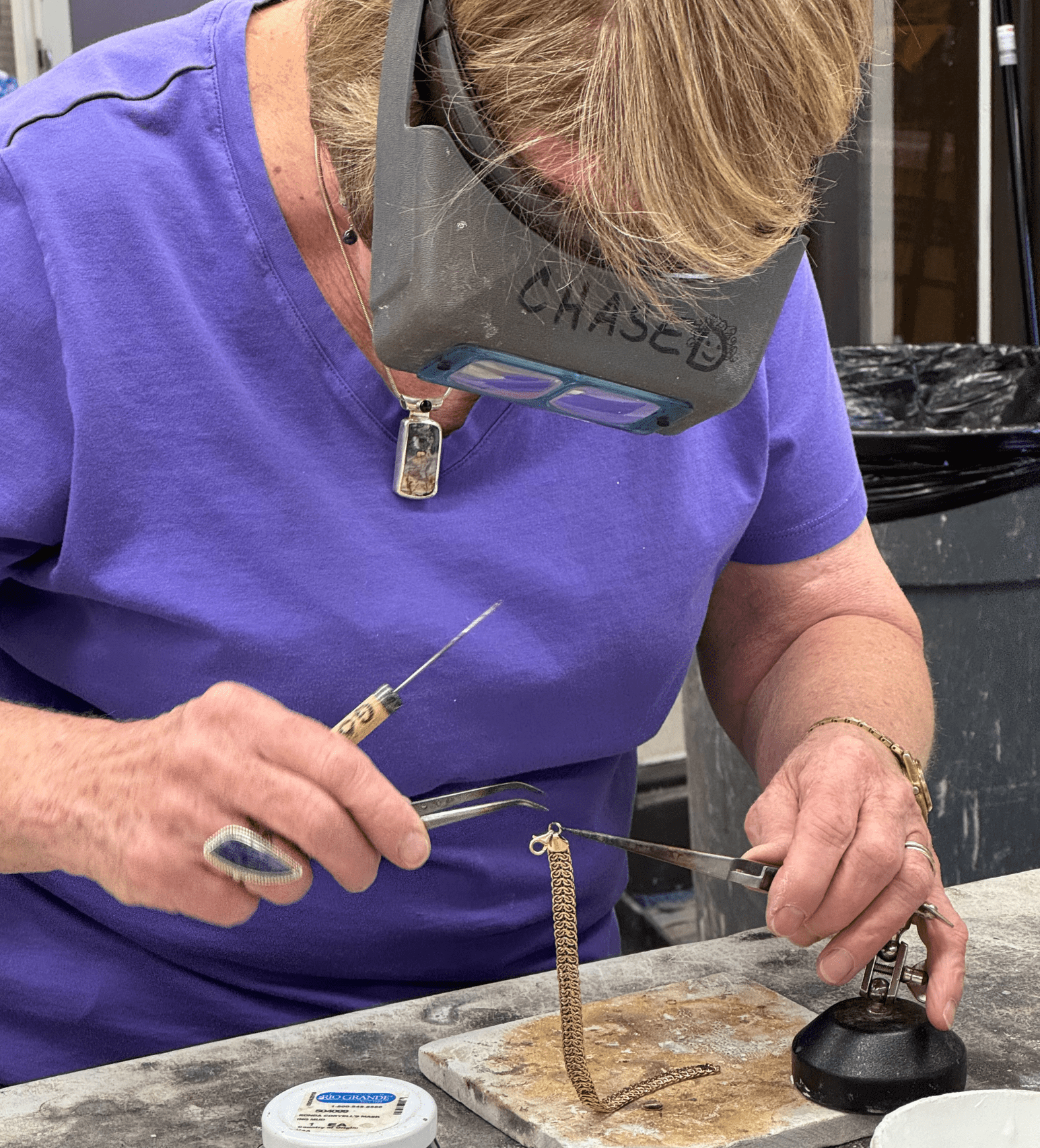 Lady working on silver jewelry.