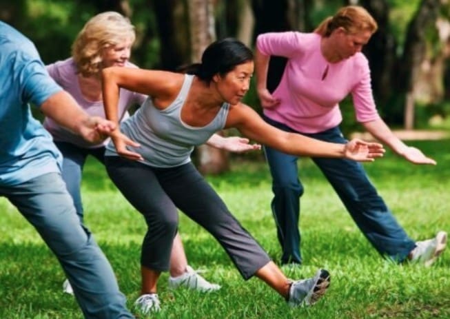 People exercising in the grass