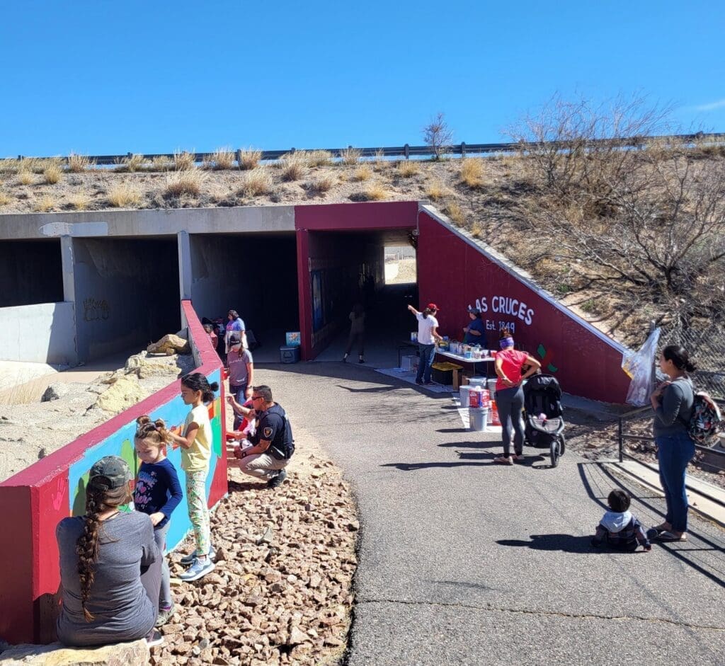 Children and adults working on the Triviz Drive Mural