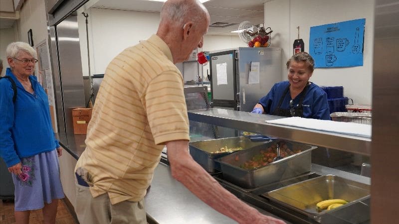 man going through a lunch line