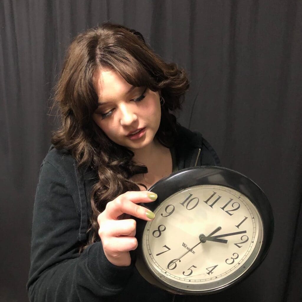 Woman holding a clock