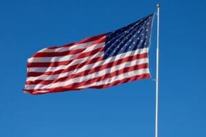 American flag waving in the blue sky