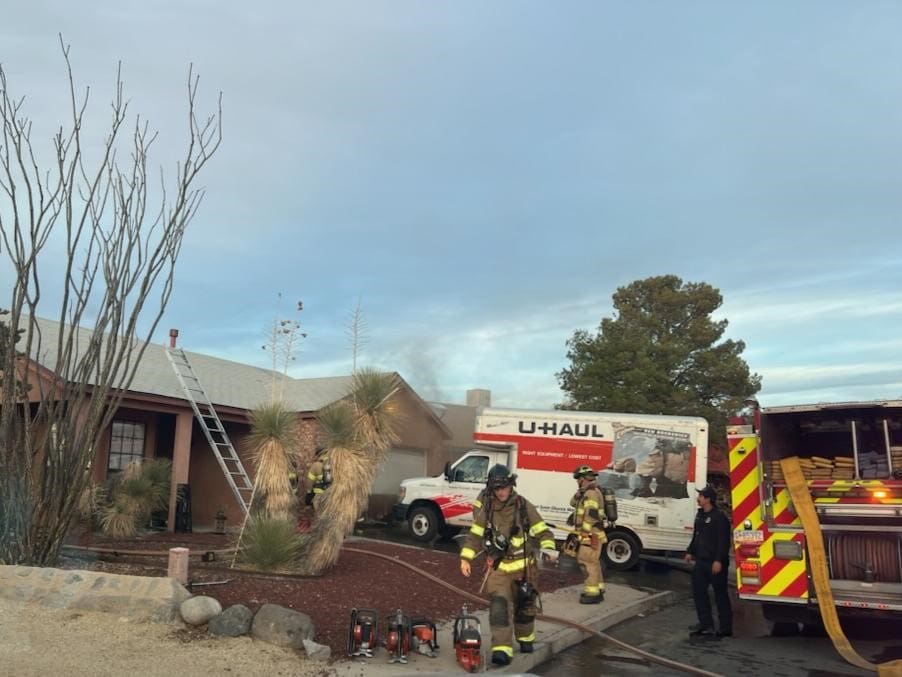 Fire fighters standing in front of a house