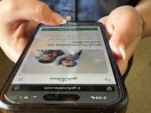 Cell phone with Go Fund Me ad.