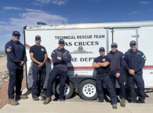 Six firefighters standing in front of the LCFD's Swiftwater Rescue trailer.