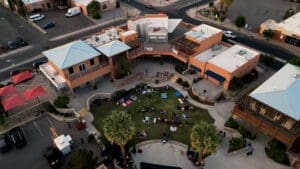 Aerial of the Amador Live venue. A lawn full of people are behind the buidling.