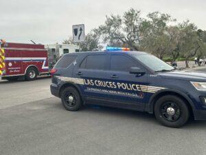 Police vehicle parked in a parking lot in front of a fire truck.
