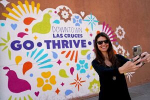 woman taking a selfie at Downtown Las Cruces mural