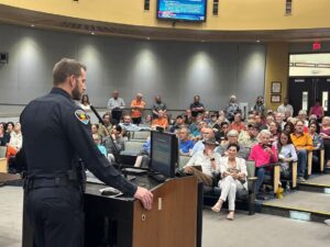 Police Chief Story speaking to public from a podium.