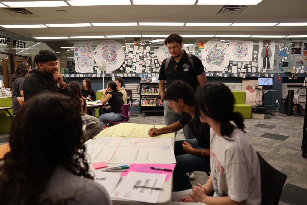 Students engaging in a project at the library.