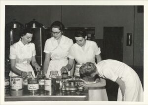 Four women canning food.