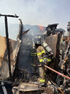 Firefighters fighting a fire in a badly damaged building.