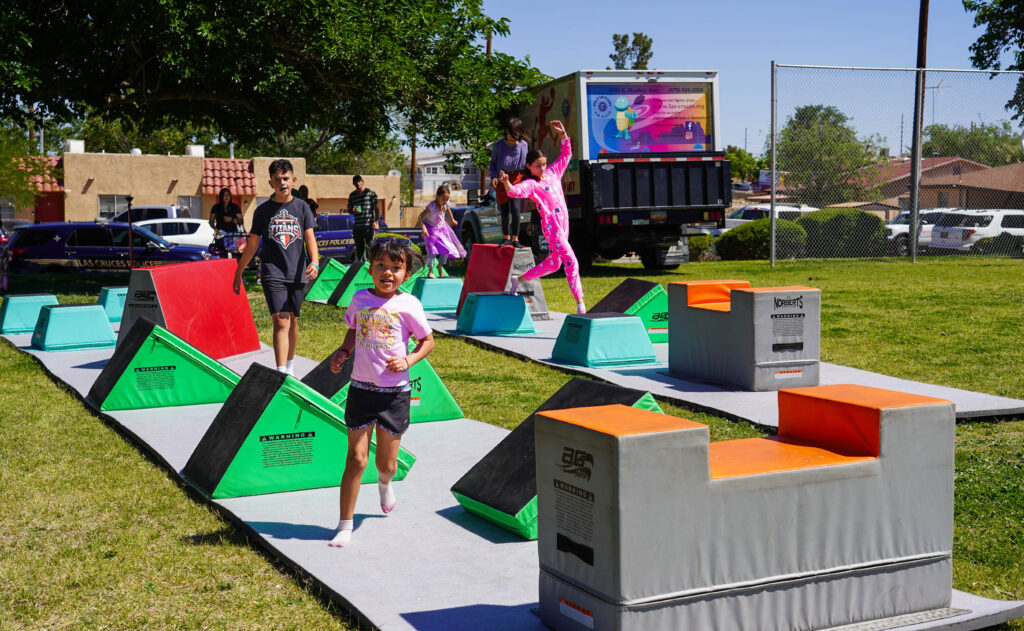 Children playing at an outdoor obstacle course.