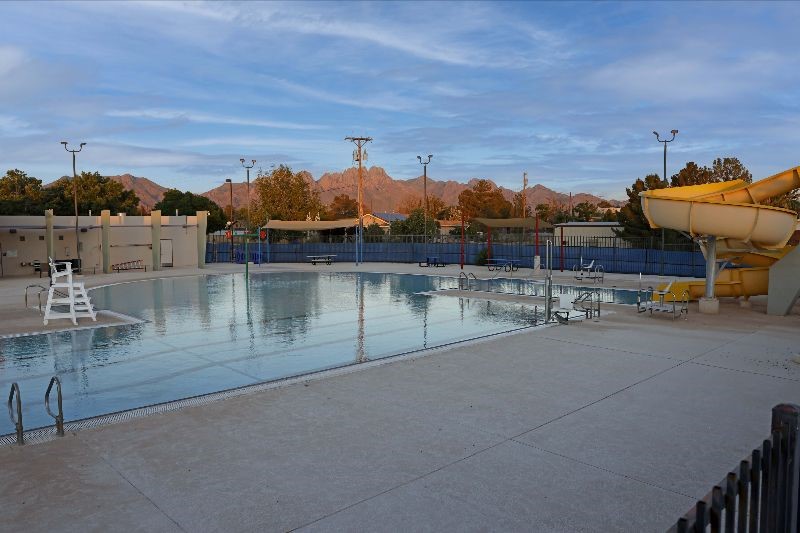 Outdoor swimming pool with the mountains in the background.