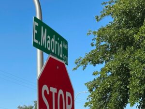 Street sign on top of a stop sign.
