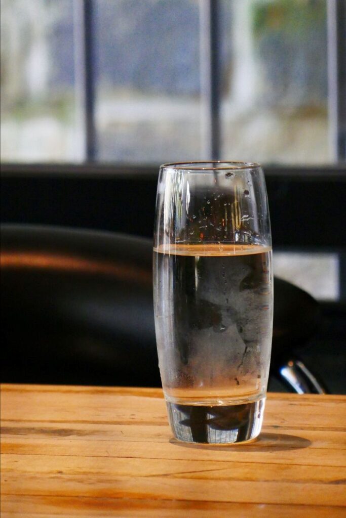 A glass of water on a table.
