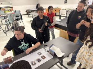 Teens interacting with Parks and Recreation staff at a table.