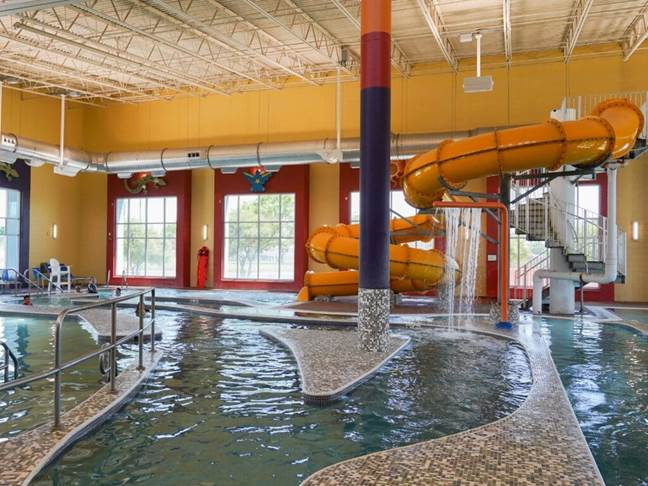 The Aquatic Center activity pool with a slide on one side.
