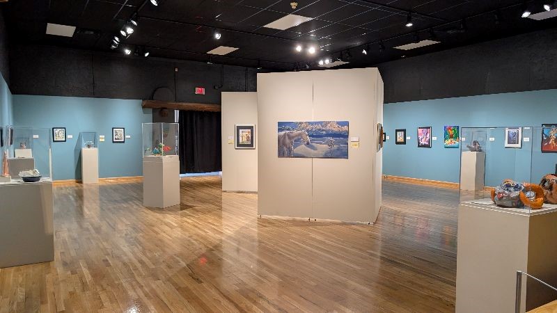 A room inside the Branigan Cultural Center with art pieces on display.