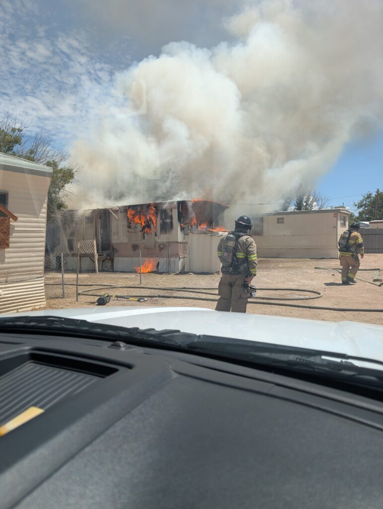Fire and smoke coming out of a mobile home.