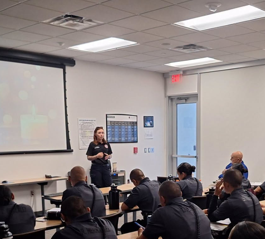 Las Cruces fire department employee in the front of a classroom giving instruction to a classroom of cadets.