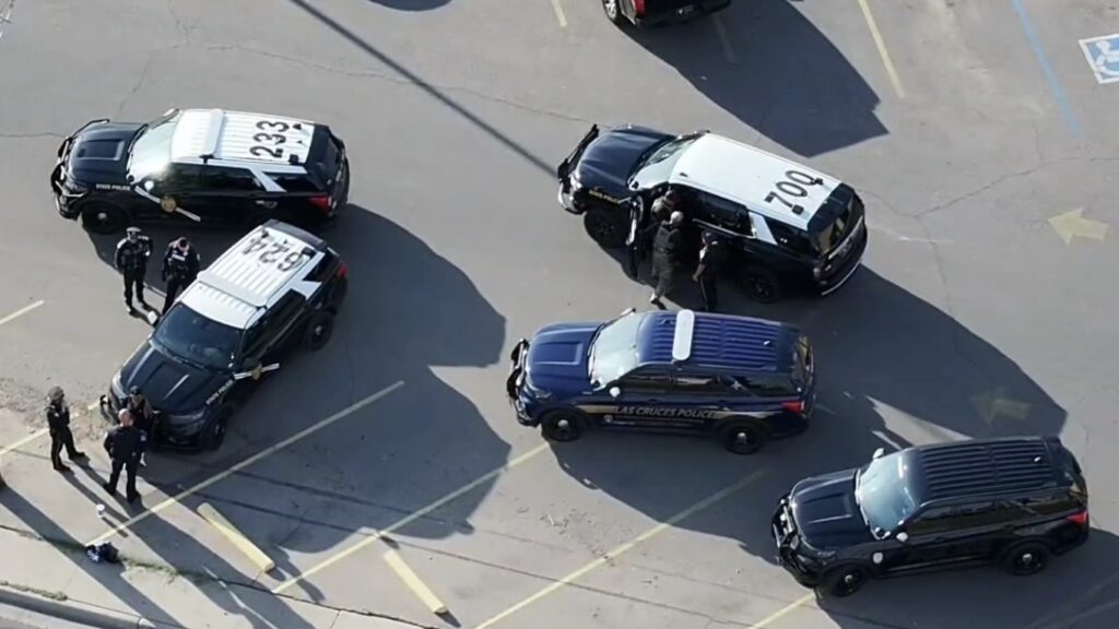 Aerial view of five police vehicles.
