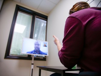 Person having a telehealth consultation with a vide screen.