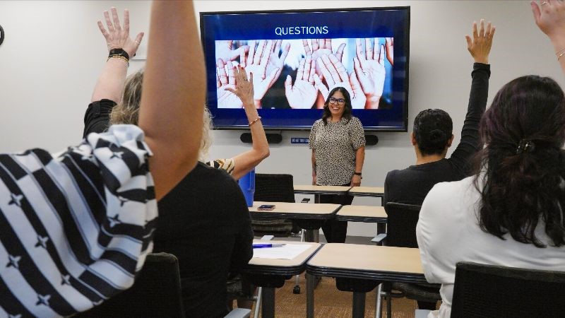 Students raising their hand for questions.
