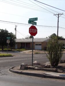 Stop sign on the corner of an intersection.