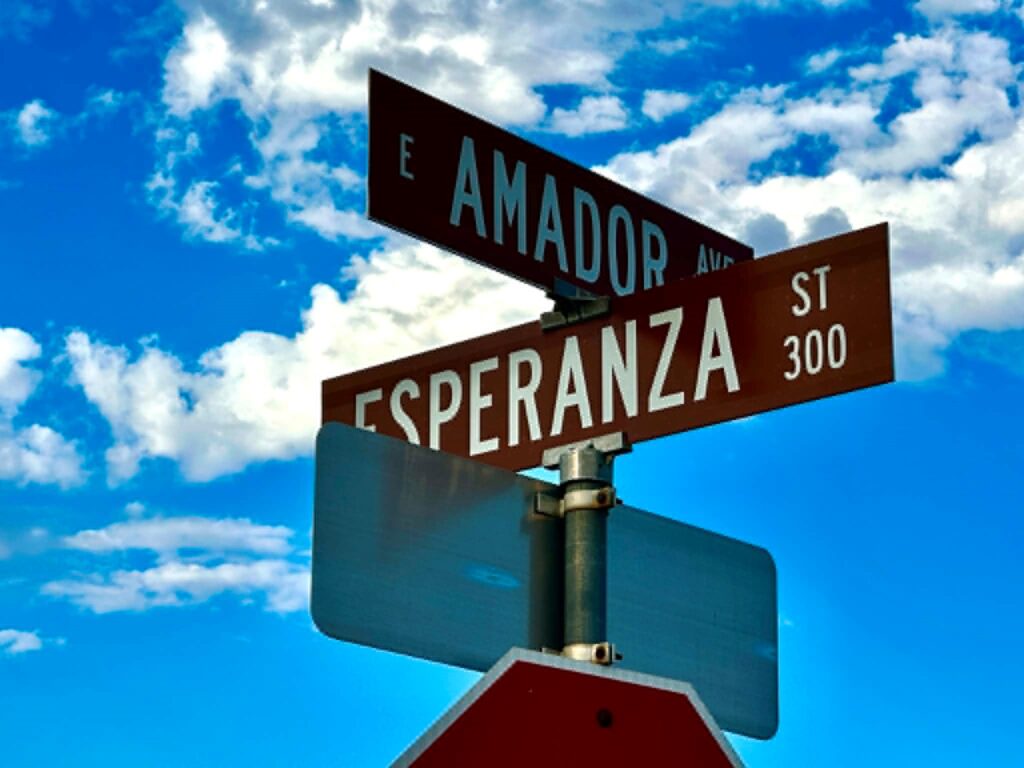 Street sign with clouds in the background.