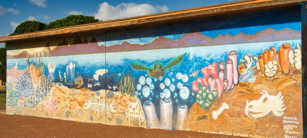 Mural on side of building that features a fantasy underwater sea life landscape.