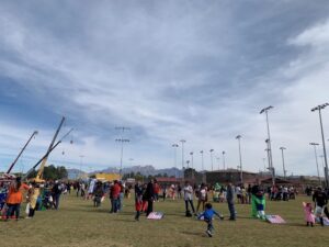 a photo of a park with children in halloween costumes getting candy