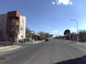 a photo of a street with white markings and a building