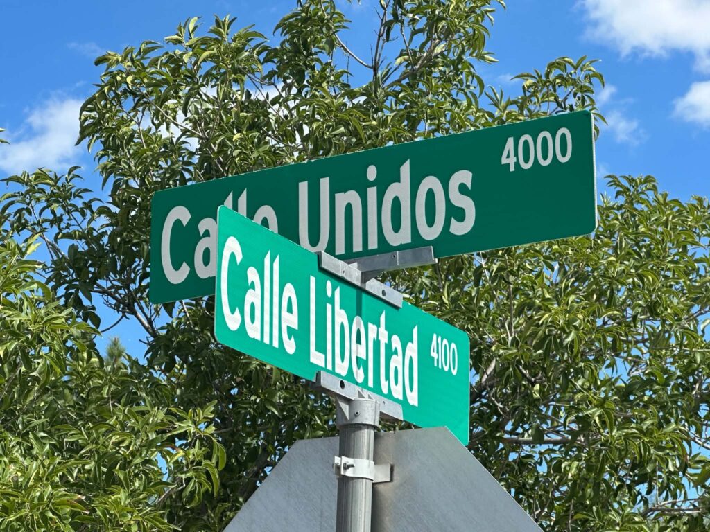 a photo of two street name signs Calle Unidos and Calle Libertad